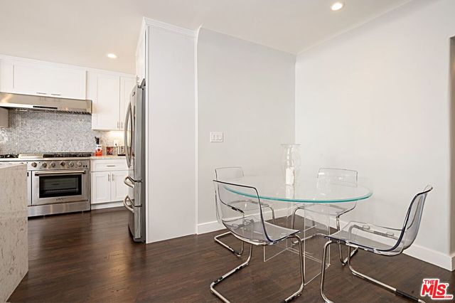a kitchen with granite countertop a stove and a refrigerator