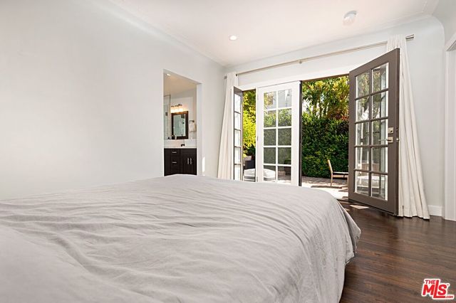 a bedroom with a large bed and a large window