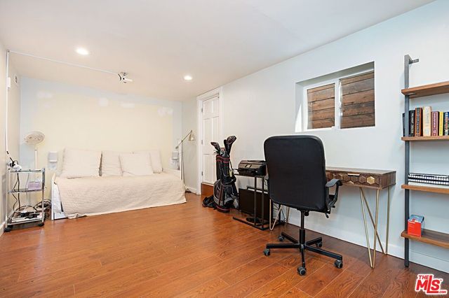 a view of a workspace with furniture and a window