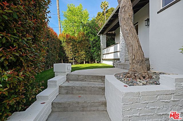 a view of a couches in the patio with a fountain and a fire pit