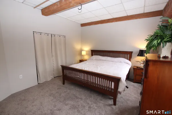 a bedroom with a bed and a table
