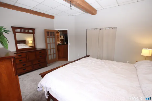a bedroom with a bed and a dresser