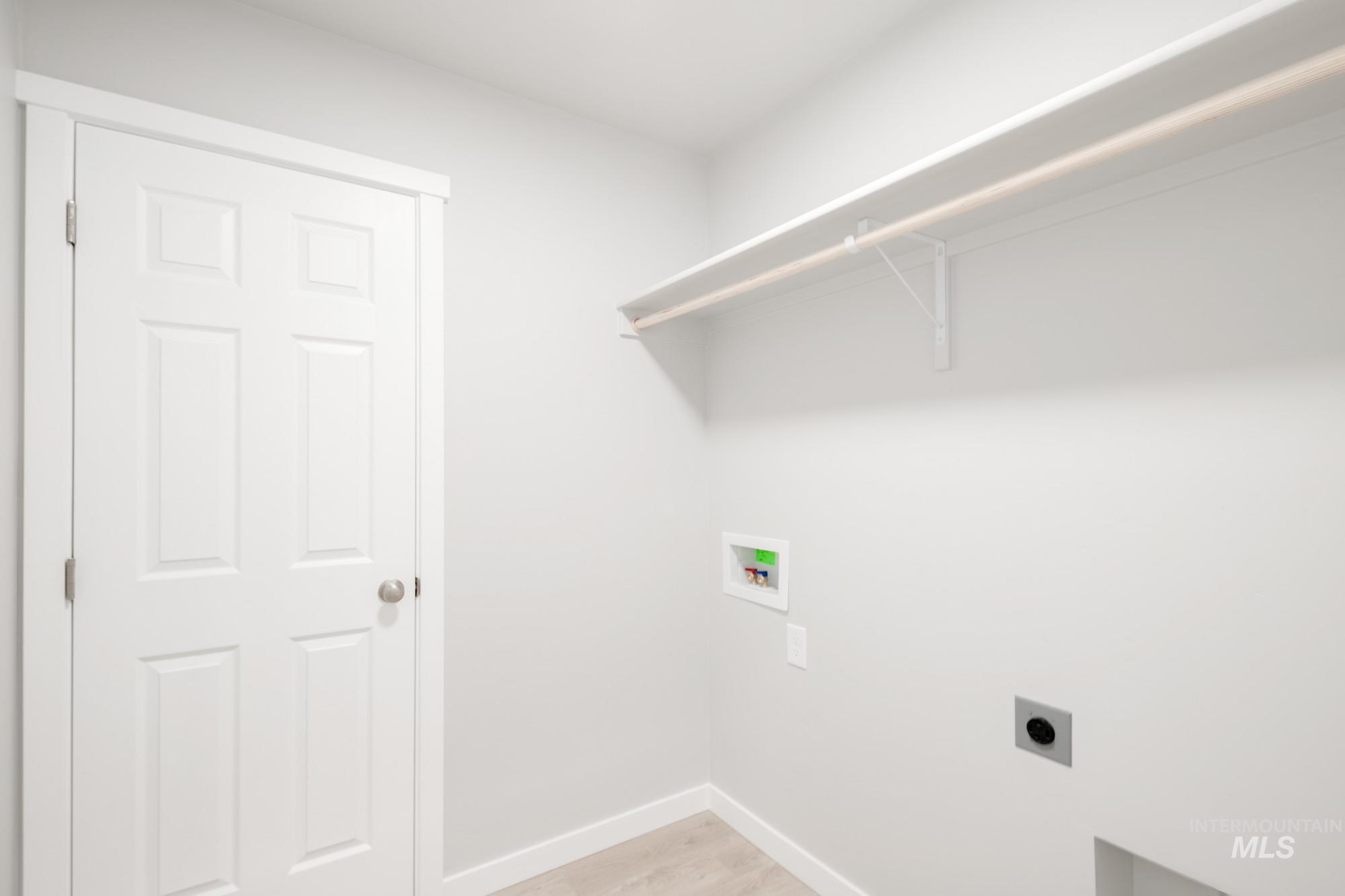 229 Moose Street Horseshoe Bend, ID 83629 - Photo 17 of 27 Washroom featuring electric dryer hookup, hookup for a washing machine, and light wood-style floors