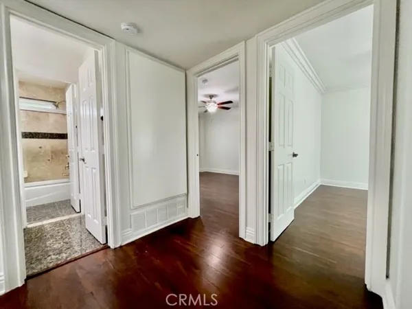 a view of a hallway with wooden floor