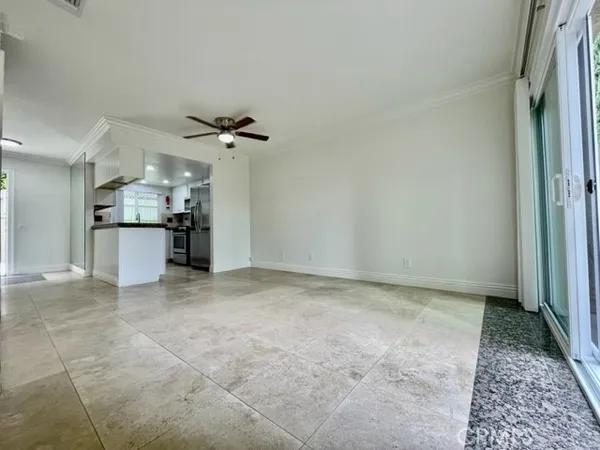 a view of a kitchen with a sink and a ceiling fan