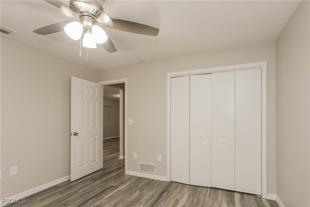 1054 Mohegan Road Venice, FL 34293 - Photo 12 of 16 an empty room with wooden floor closet and windows
