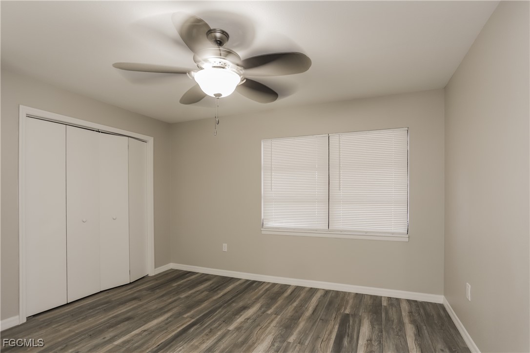1054 Mohegan Road Venice, FL 34293 - Photo 13 of 16 an empty room with wooden floor fan and windows