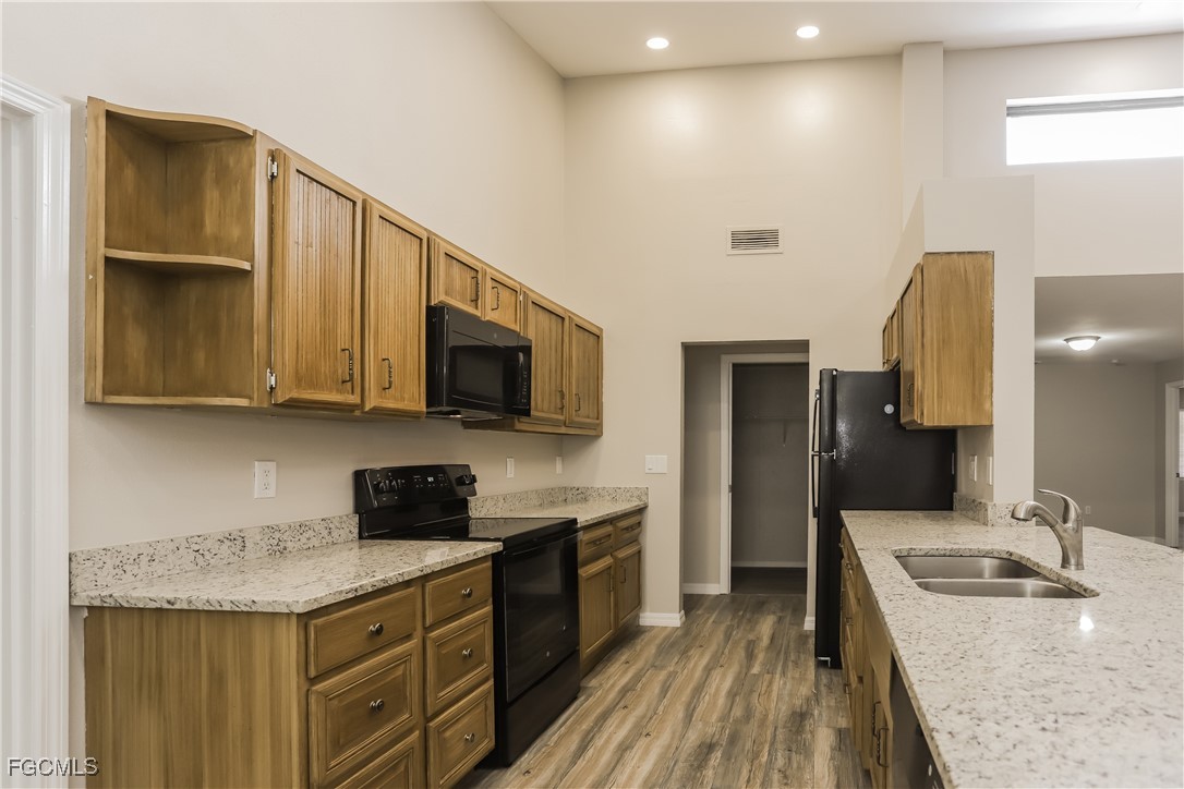 1054 Mohegan Road Venice, FL 34293 - Photo 4 of 16 a kitchen with granite countertop a sink a stove and cabinets