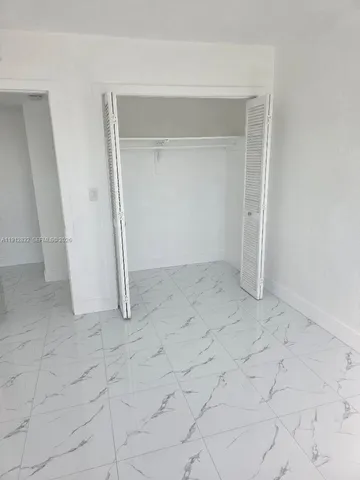 a bathroom with a shower and a glass door