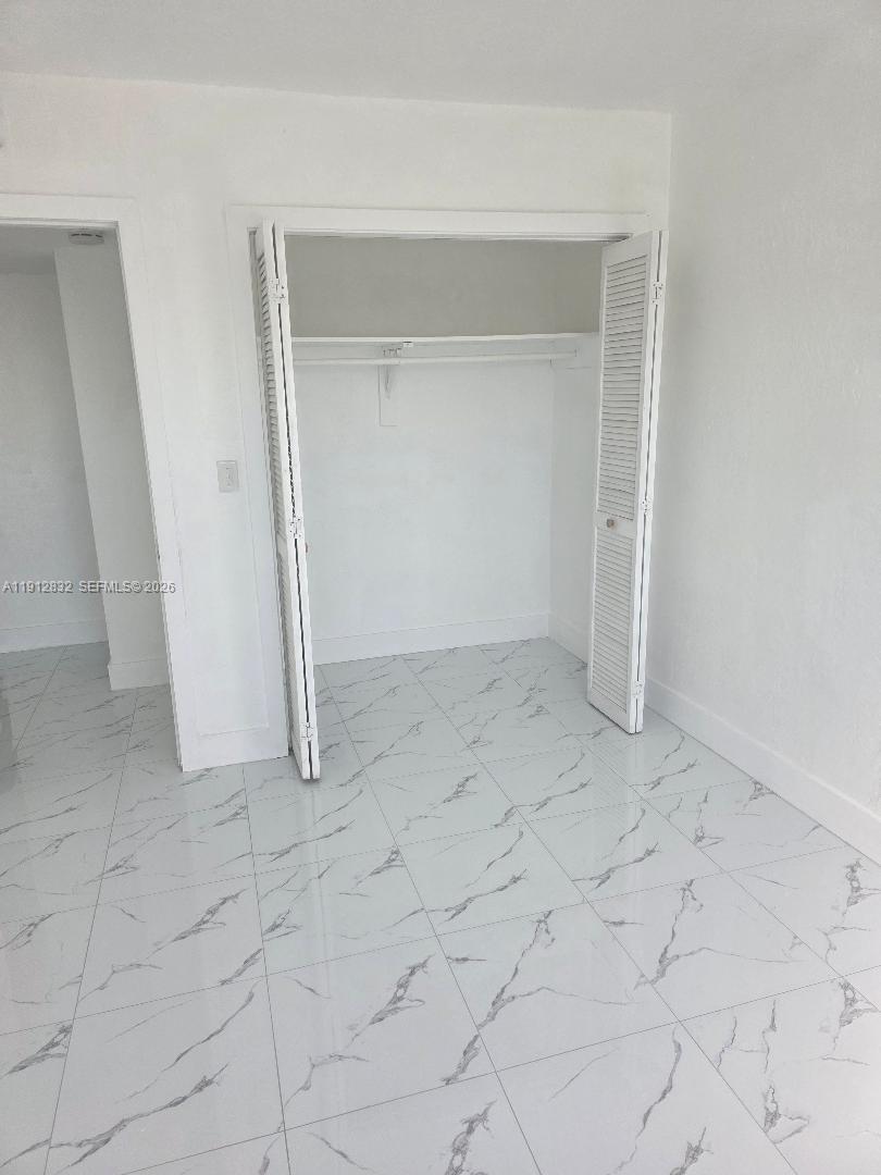 340 West 19th Street, Unit 10 Hialeah, FL 33010 - Photo 12 of 14 an empty room with white door