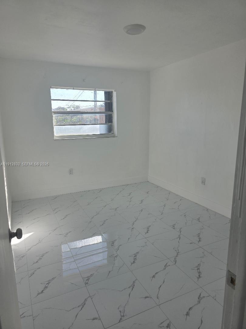 340 West 19th Street, Unit 10 Hialeah, FL 33010 - Photo 7 of 14 en empty room with windows