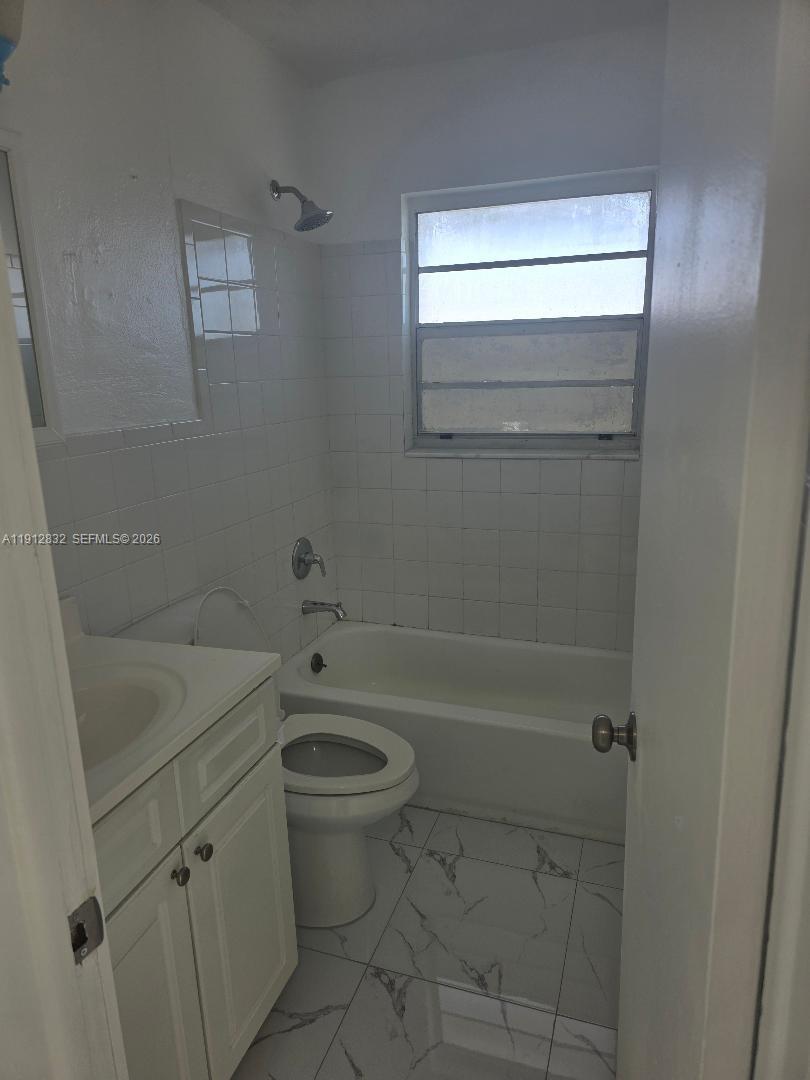 340 West 19th Street, Unit 10 Hialeah, FL 33010 - Photo 9 of 14 a bathroom with a sink a toilet and shower