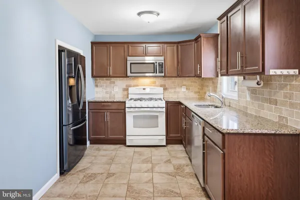a kitchen with a stove sink and refrigerator