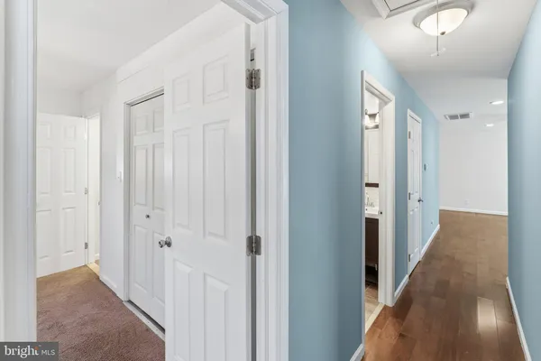a view of a hallway with wooden floor