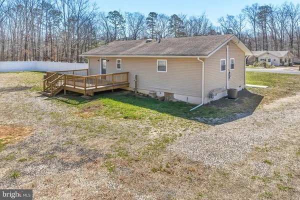 a backyard of a house with yard and trampoline