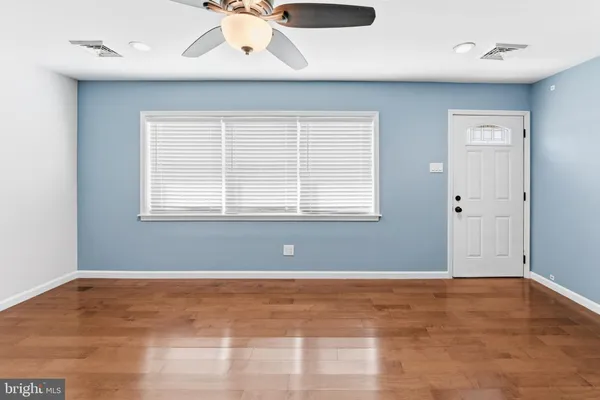 a view of wooden floor and windows in a room