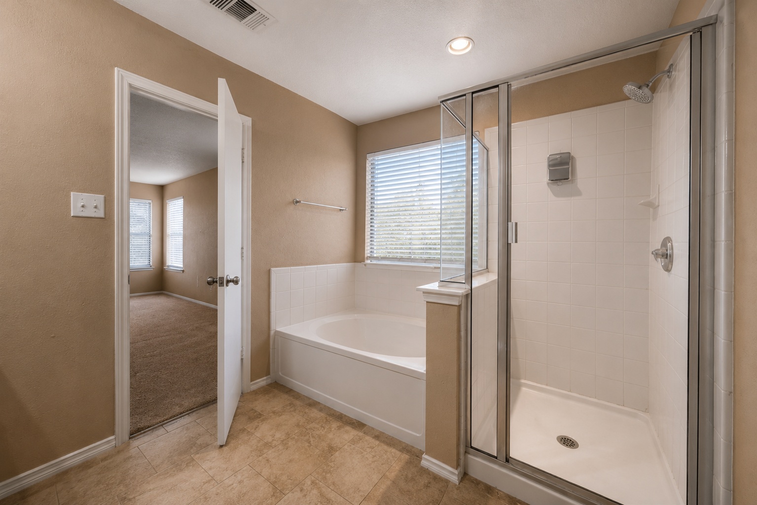 122 Rummel Drive Kyle, TX 78640 - Photo 11 of 18 Relax in the deep soaking tub or step into the separate shower in this full bathroom.
