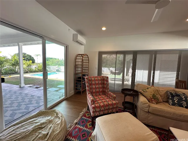 a living room with furniture and a floor to ceiling window