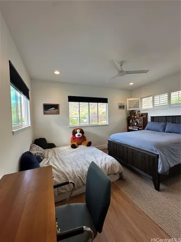 a bedroom with two beds and a window