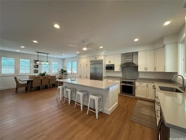 a kitchen with lots of counter top space and stainless steel appliances