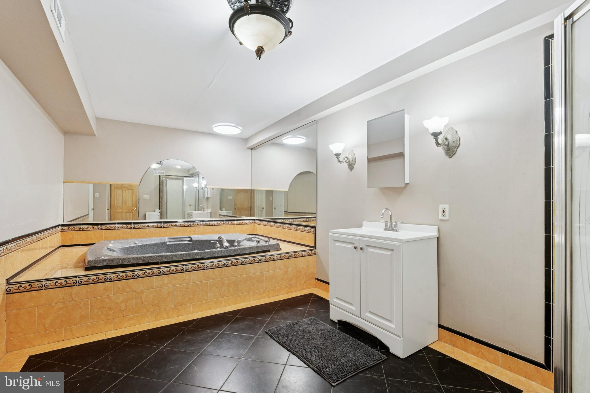 614 Wises Mill Road Philadelphia, PA 19128 - Photo 16 of 42 a kitchen with a stove and white cabinets