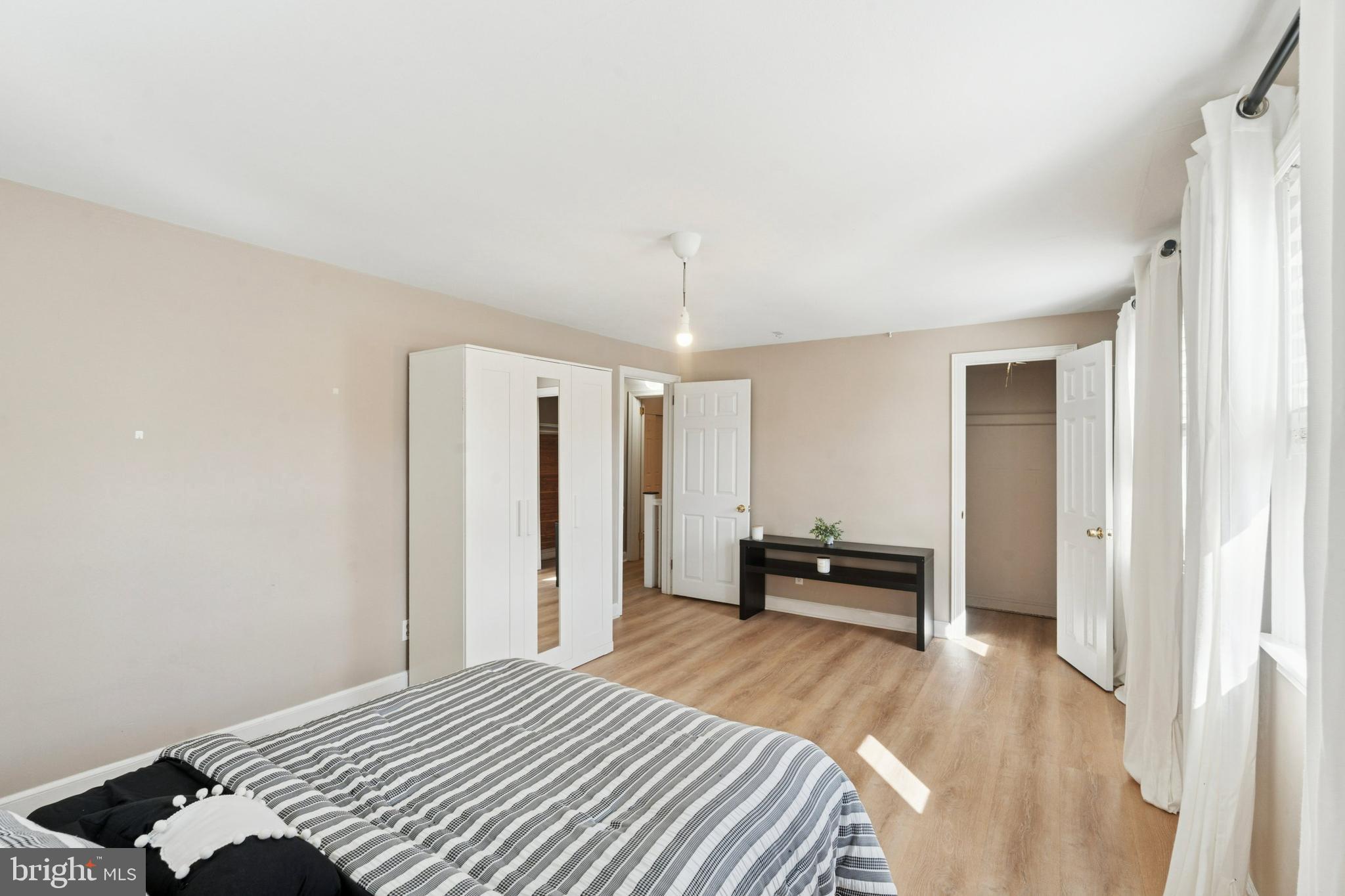 614 Wises Mill Road Philadelphia, PA 19128 - Photo 24 of 42 a bedroom with a bed and a chandelier