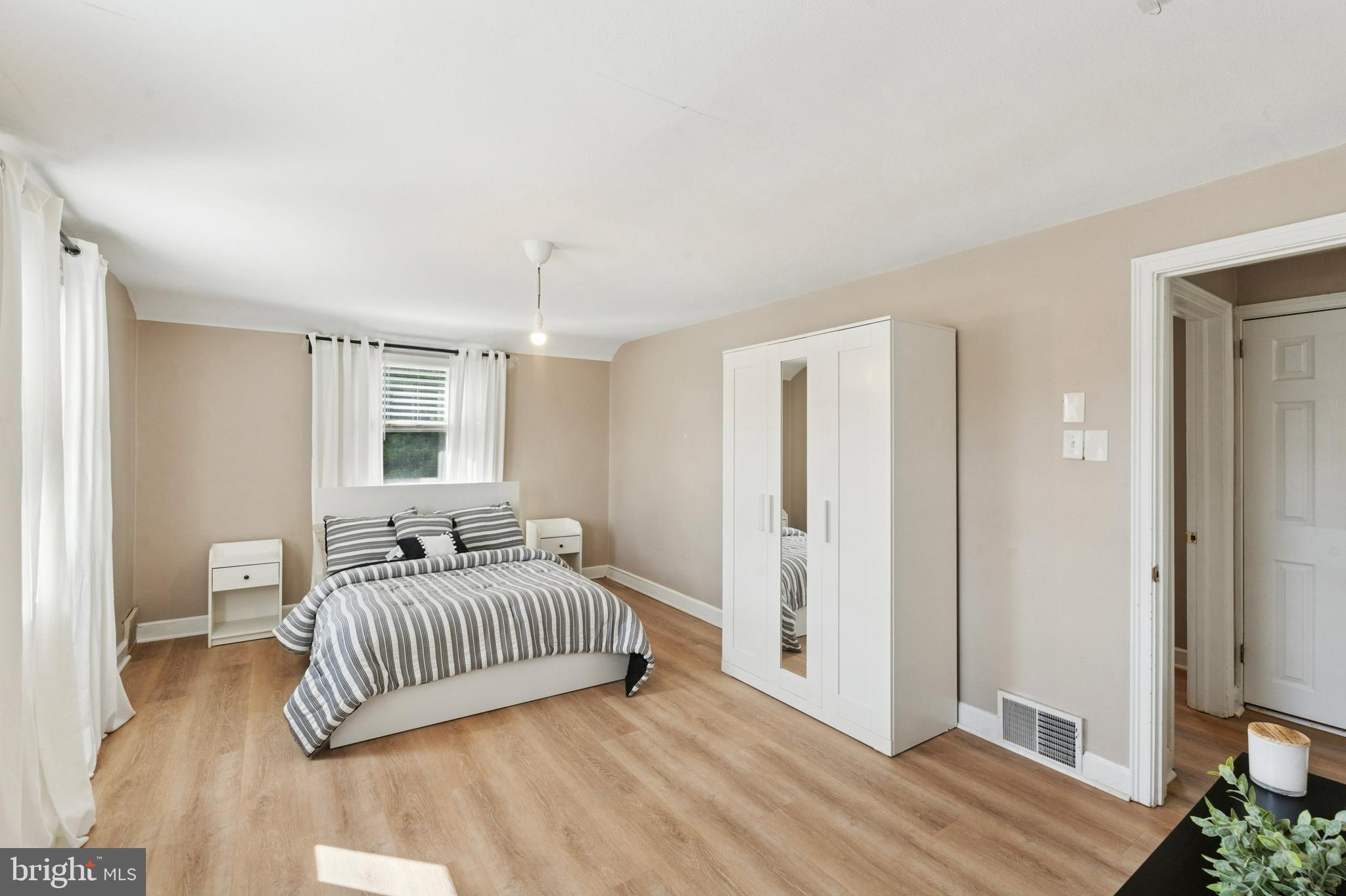 614 Wises Mill Road Philadelphia, PA 19128 - Photo 25 of 42 a bedroom with a bed and wooden floor