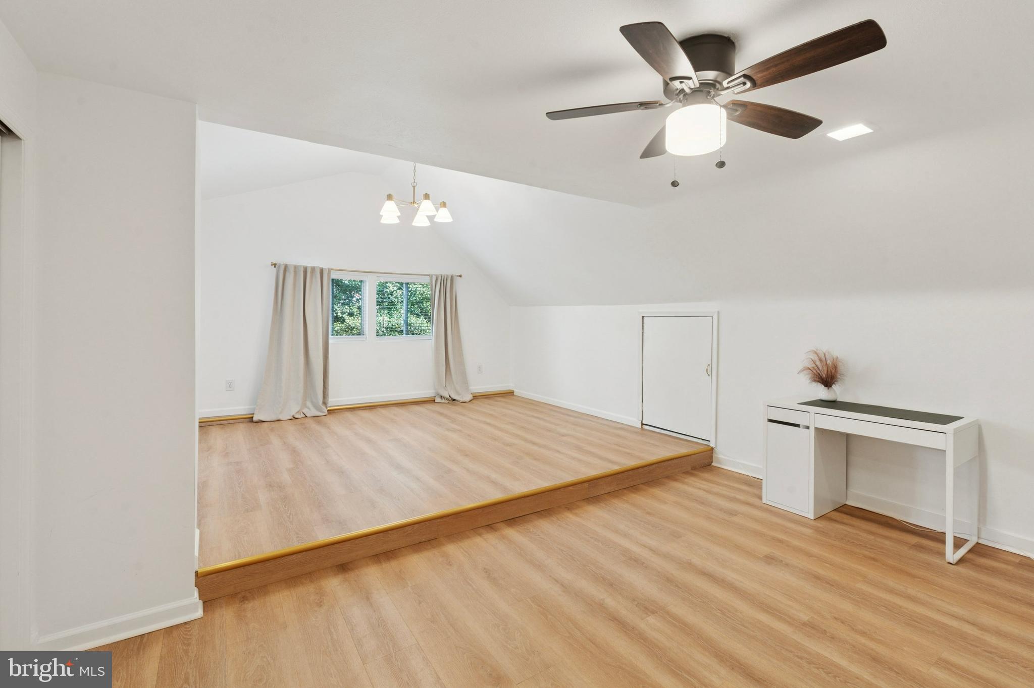 614 Wises Mill Road Philadelphia, PA 19128 - Photo 33 of 42 a bedroom with a bed and a chandelier
