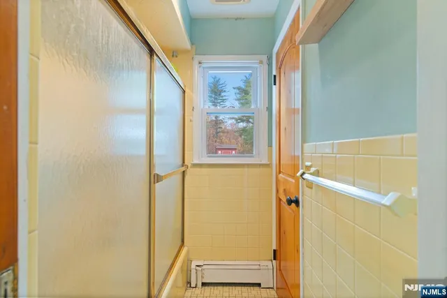 a bathroom with a shower and a window