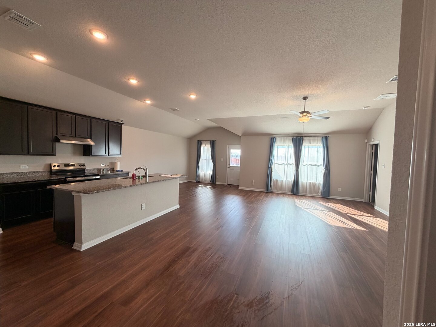 20929 Pleasanton Road San Antonio, TX 78264 - Photo 10 of 51 a view of a kitchen with a sink and dishwasher a stove top oven with wooden floor