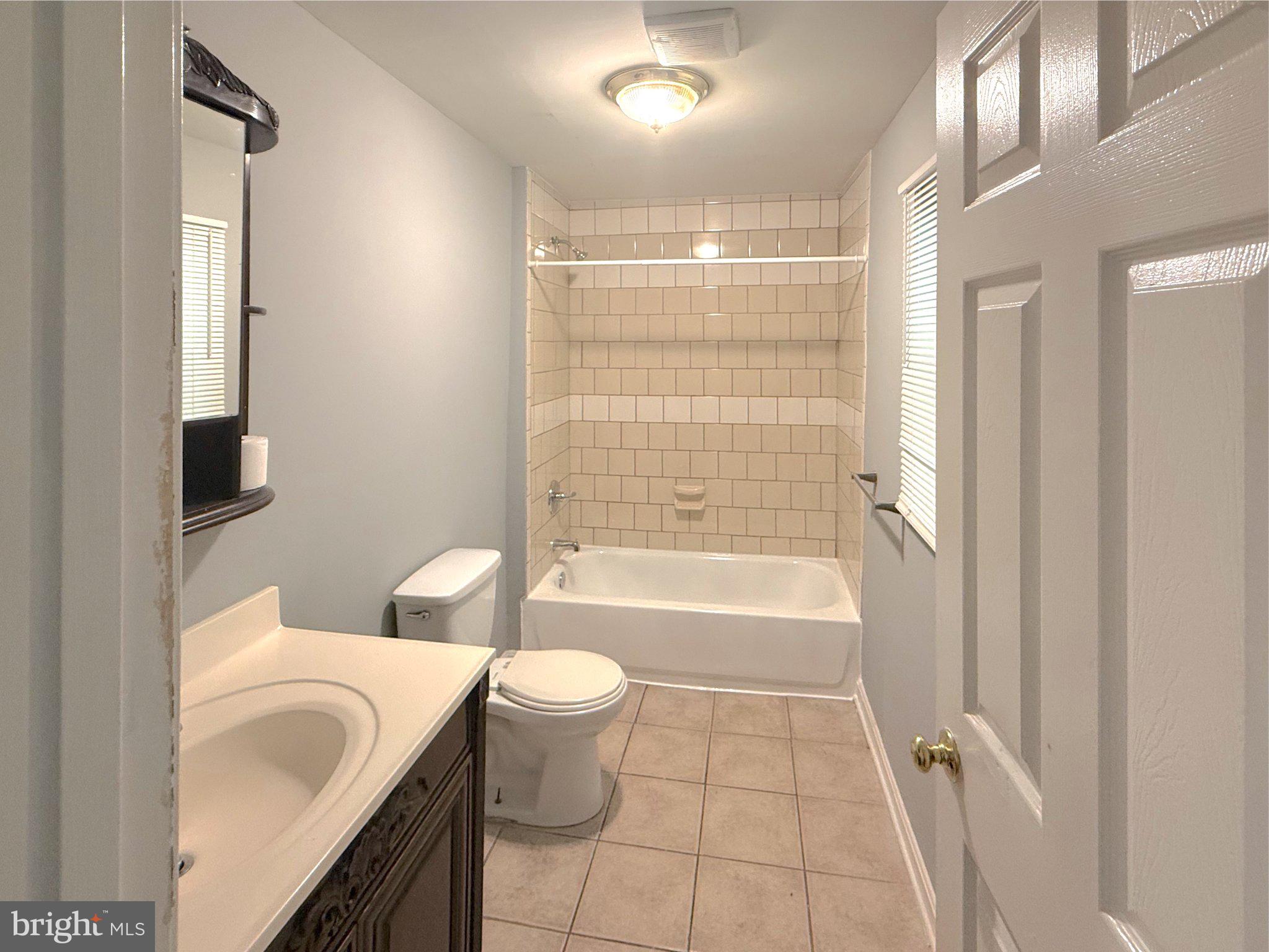 304 Collins Avenue, Unit 2 Baltimore, MD 21229 - Photo 3 of 17 Modern bathroom with tiled elegance.