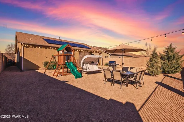 a view of a patio with a table and chairs