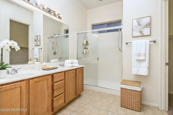 a bathroom with a sink a mirror and a shower