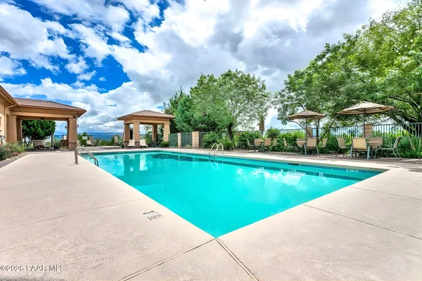 a view of swimming pool is middle in the garden
