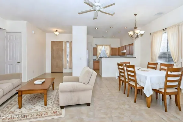 a living room with furniture a dining table and a chandelier