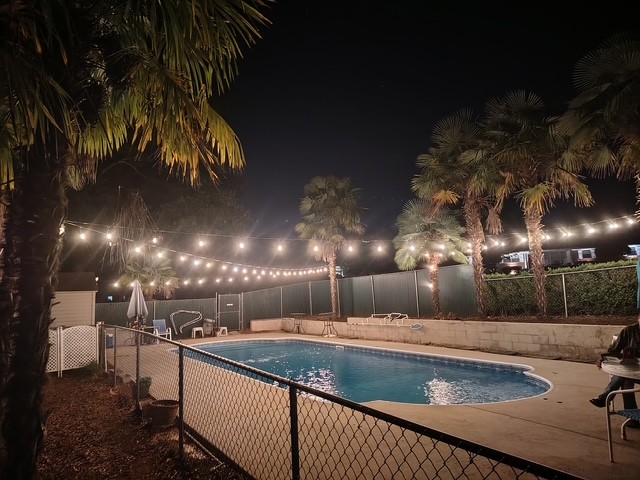 2101 Old Spring Drive Anderson, SC 29625 - Photo 36 of 36 A private swimming pool beckons under the soft glow of string lights and towering palm trees.