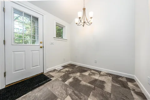a room with wooden floor and a window