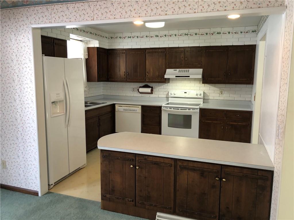 140 Redstone Furnace Road Hopwood, PA 15445 - Photo 11 of 38 a kitchen with stainless steel appliances a stove microwave and sink
