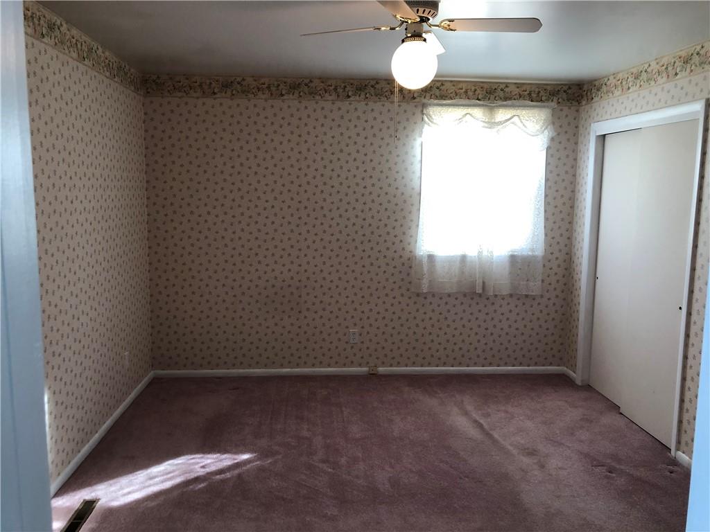 140 Redstone Furnace Road Hopwood, PA 15445 - Photo 19 of 38 en empty room with a window and chandelier