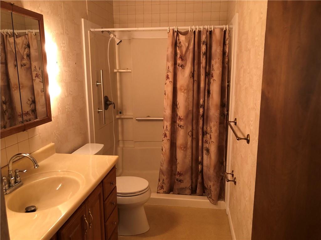 140 Redstone Furnace Road Hopwood, PA 15445 - Photo 25 of 38 a bathroom with a sink a toilet and shower