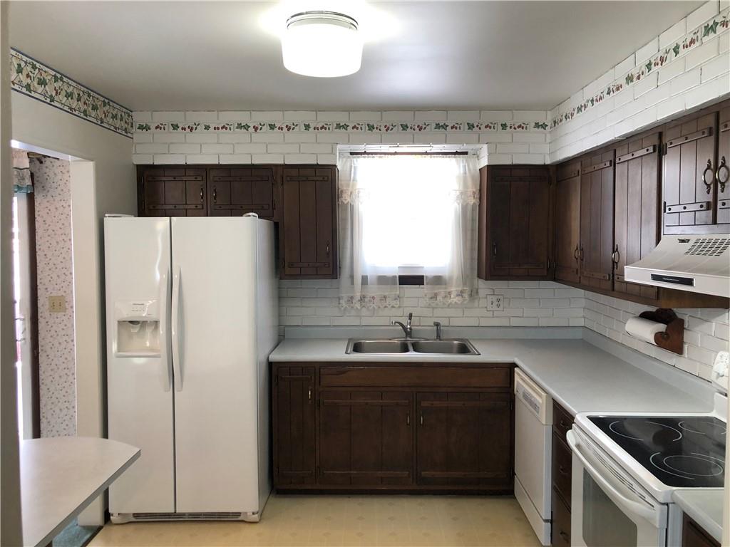 140 Redstone Furnace Road Hopwood, PA 15445 - Photo 9 of 38 a kitchen with a sink and a refrigerator