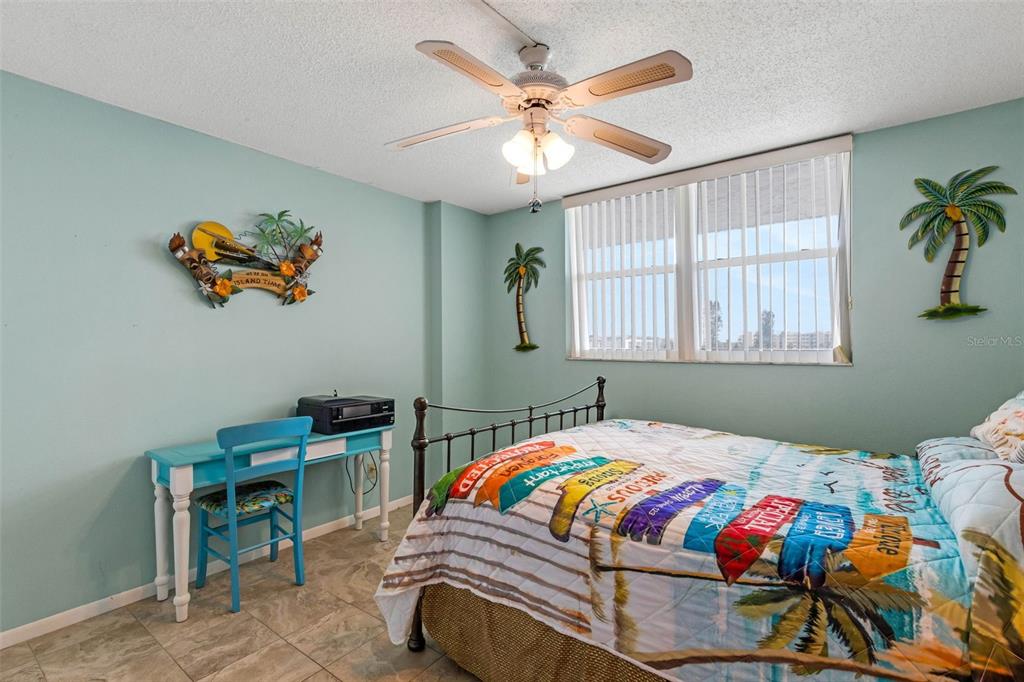 14900 Gulf Boulevard, Unit 410 Madeira Beach, FL 33708 - Photo 20 of 76 a bedroom with a bed and a table in it