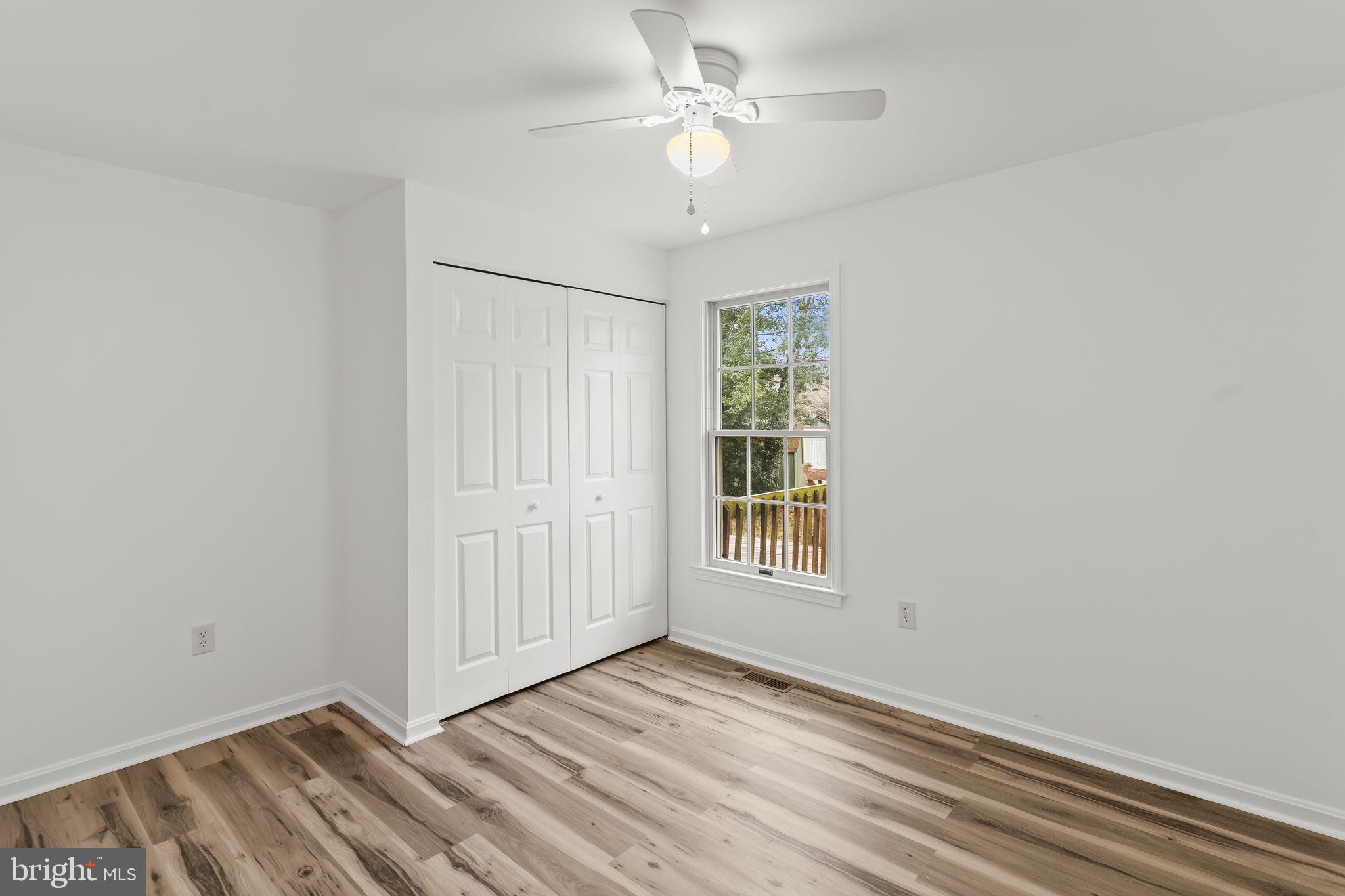 11223 Rawhide Road Lusby, MD 20657 - Photo 12 of 33 an empty room with windows and fan