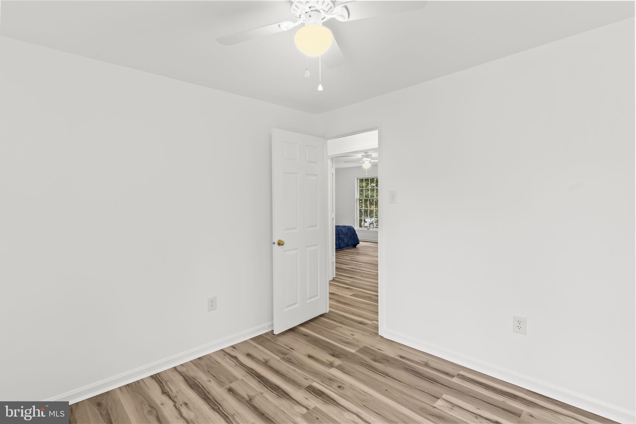 11223 Rawhide Road Lusby, MD 20657 - Photo 13 of 33 a view of an empty room with wooden floor and a window