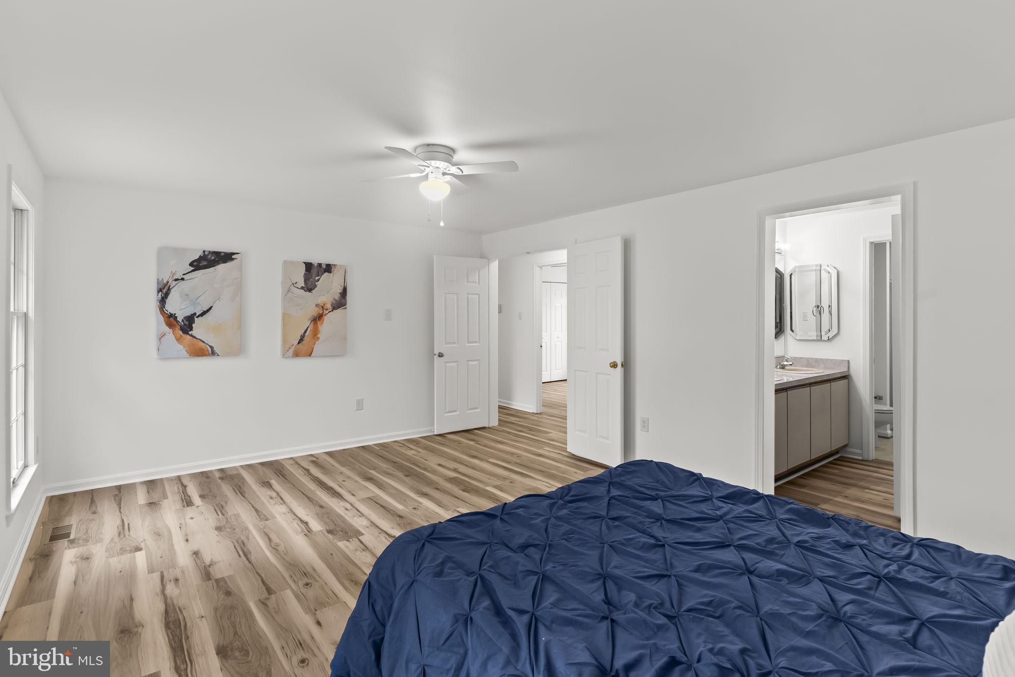 11223 Rawhide Road Lusby, MD 20657 - Photo 16 of 33 a bedroom with a bed and a painting on the wall