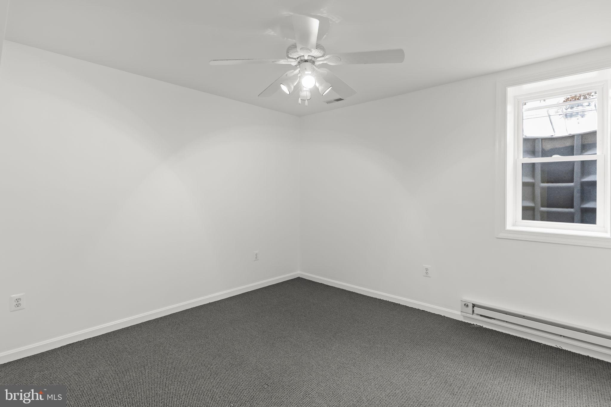 11223 Rawhide Road Lusby, MD 20657 - Photo 22 of 33 an empty room with a window and a ceiling fan