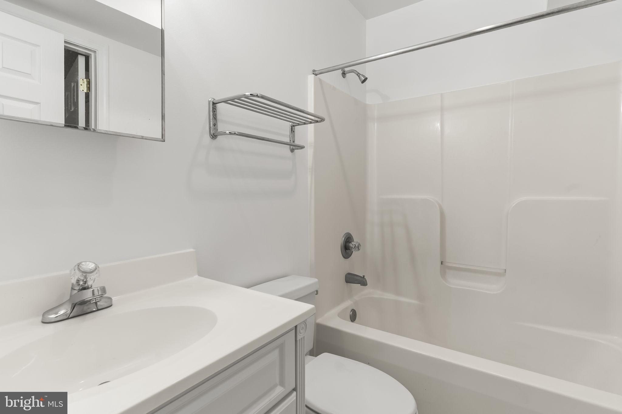 11223 Rawhide Road Lusby, MD 20657 - Photo 25 of 33 a bathroom with a sink a toilet and a bathtub