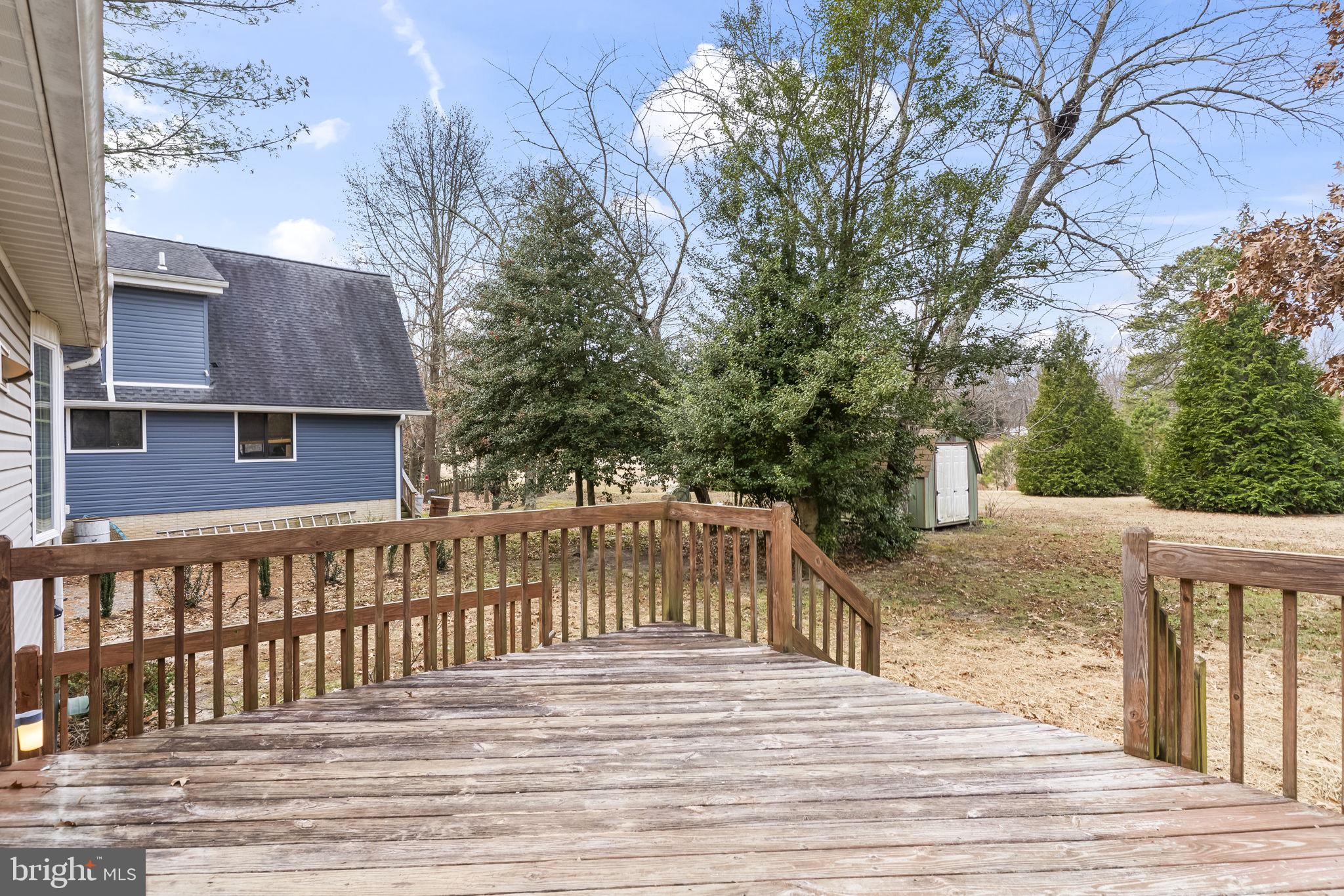 11223 Rawhide Road Lusby, MD 20657 - Photo 27 of 33 a view of a house with a wooden deck