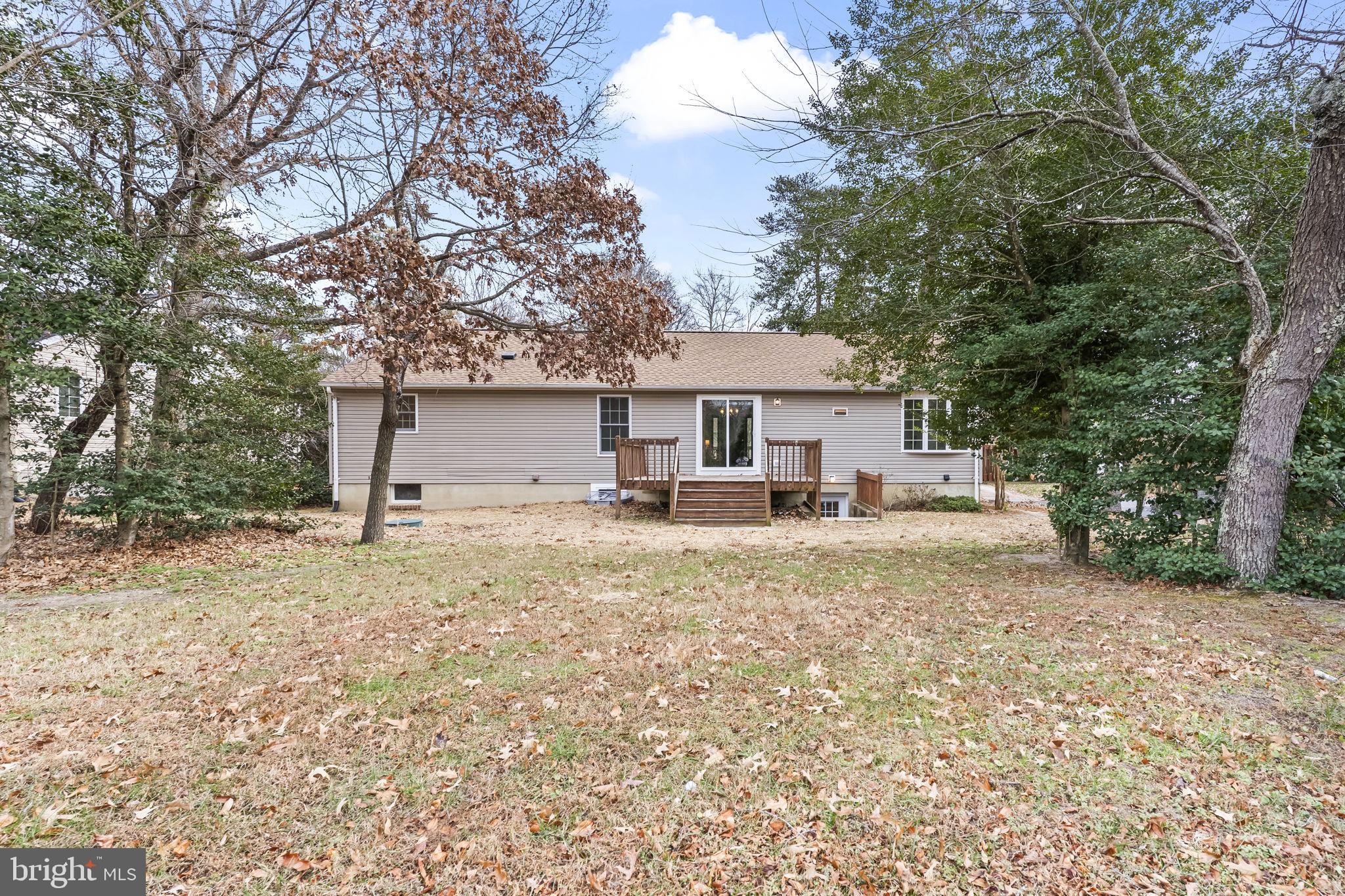 11223 Rawhide Road Lusby, MD 20657 - Photo 29 of 33 a front view of a house with a yard and garage