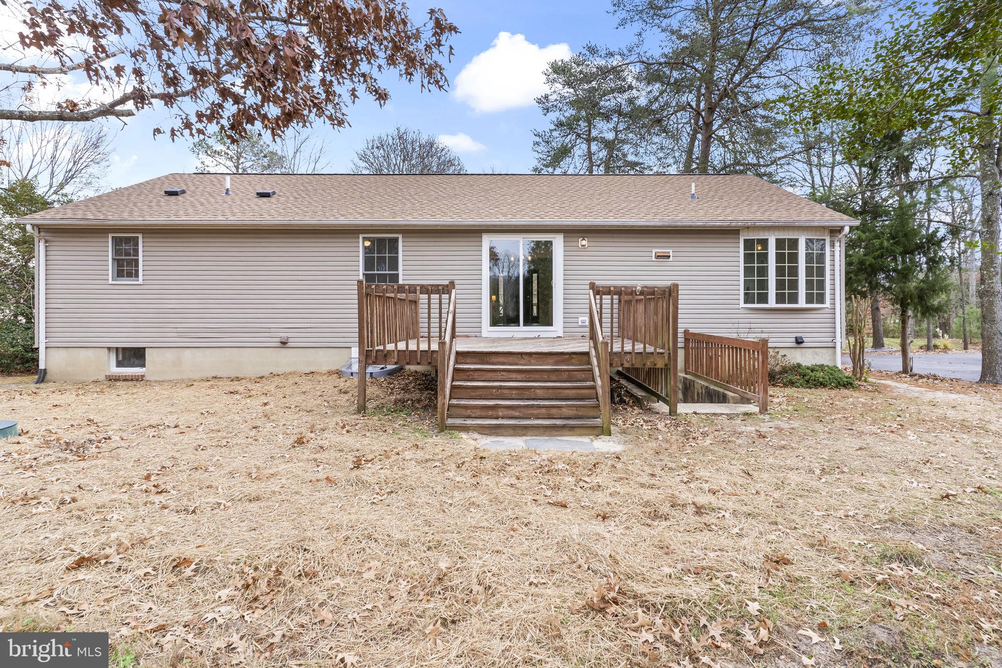 11223 Rawhide Road Lusby, MD 20657 - Photo 30 of 33 a view of a house with a backyard and chairs